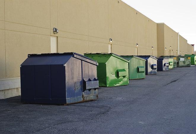 roll-off dumpsters parked at a job site in Alpine